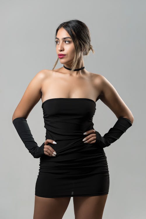 A Pretty Woman in Black Off-Shoulder Dress Posing