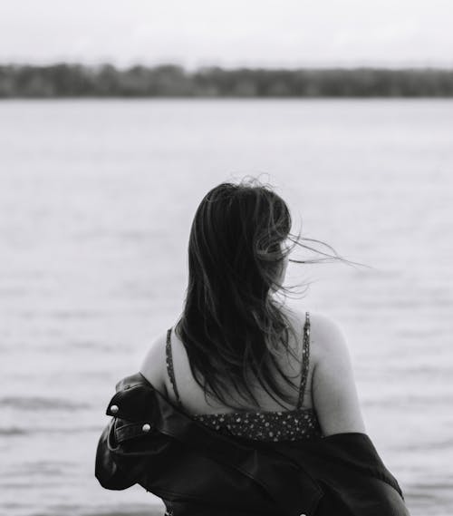 Free Back View of a Person by a Riverside Stock Photo