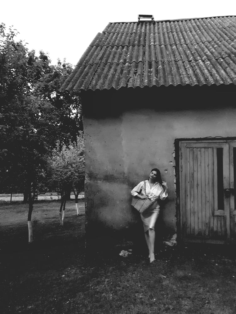 Woman Posing By House In Black And White