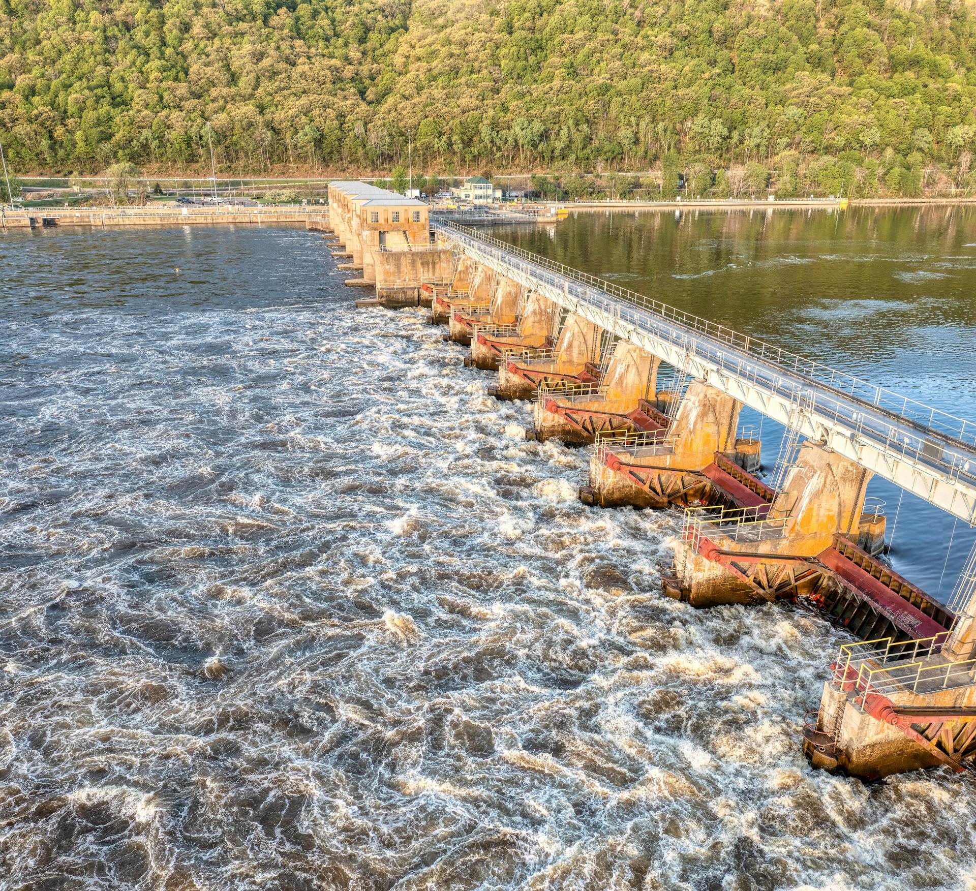 Aerial shot of a dam with flood gates controlling water flow in Minnesota, USA.