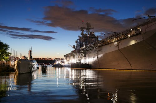 Navy Ship Sailing on the Sea Under Night Sky