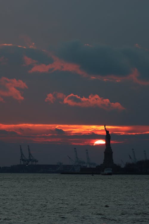 Silhouette of Statue of Liberty during Sunset