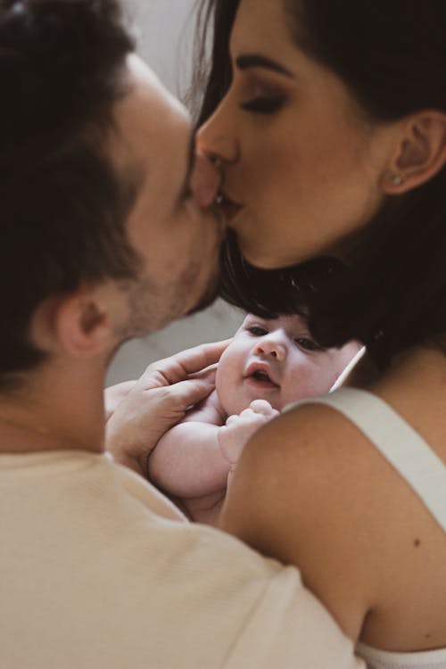 Couple Kissing with Baby