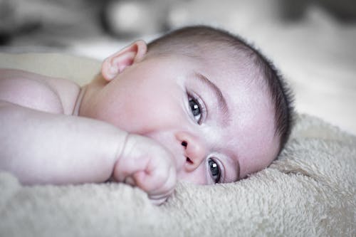 Baby Lying Down on Soft Textile