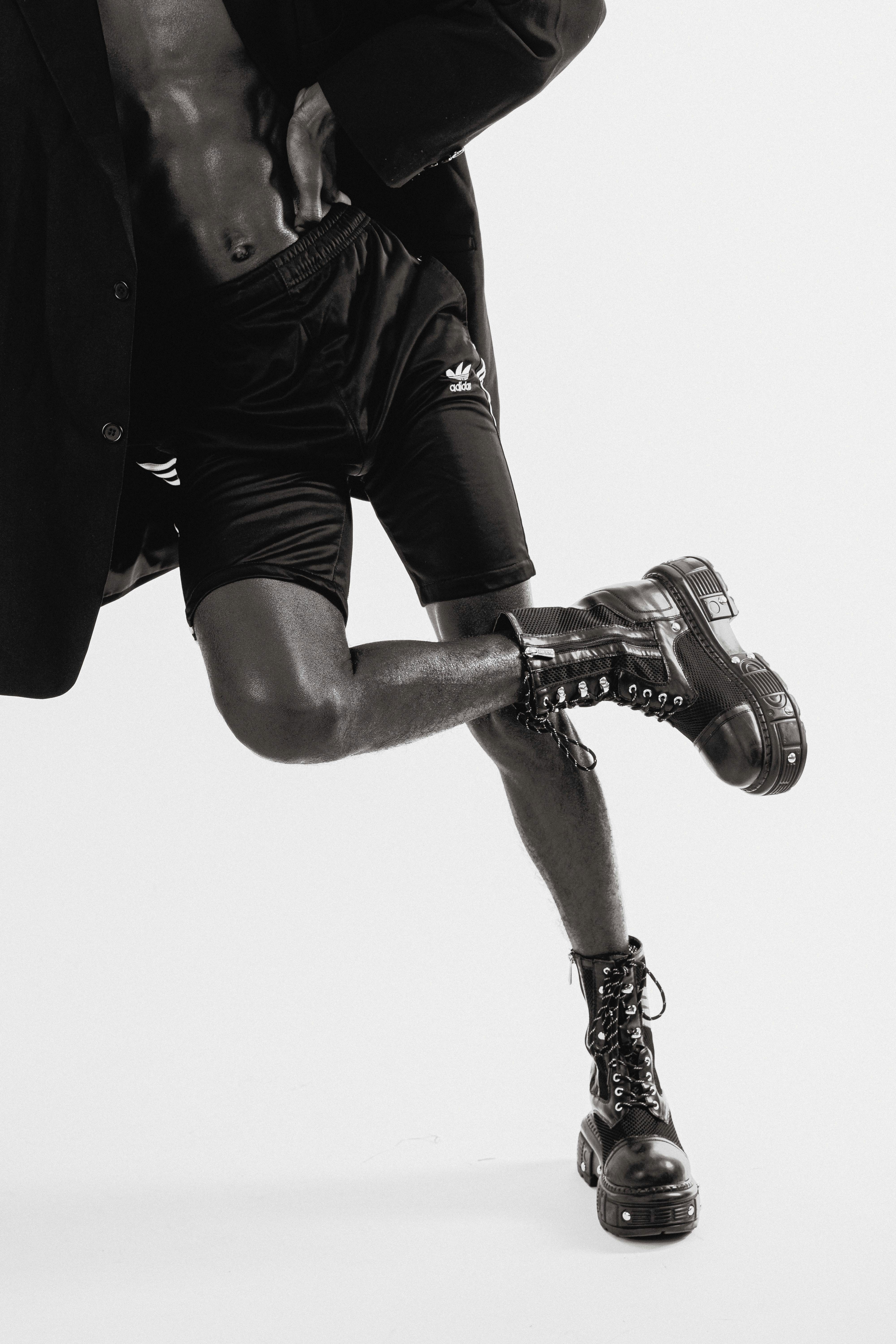 muscular man in trendy wedge shoes in studio