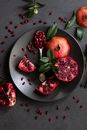 Red and Green Fruits on Black Round Plate