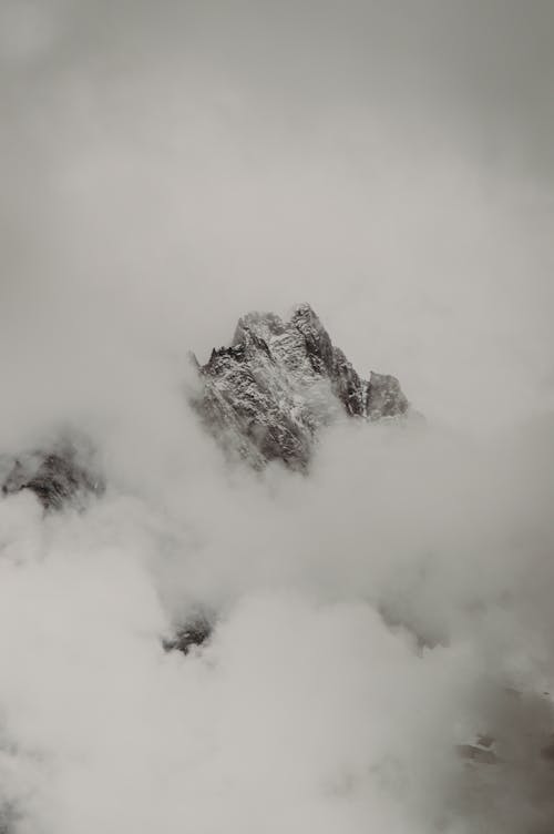 Gray and White Mountain Covered by White Clouds