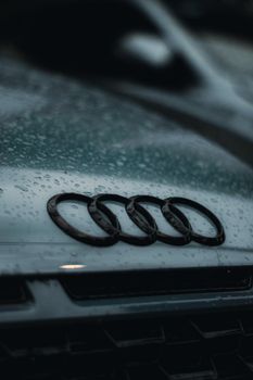 Raindrops on the hood of an Audi car, showcasing the brand's emblem. 12418665