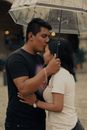 Man in Black Crew Neck T-shirt Holding White Umbrella