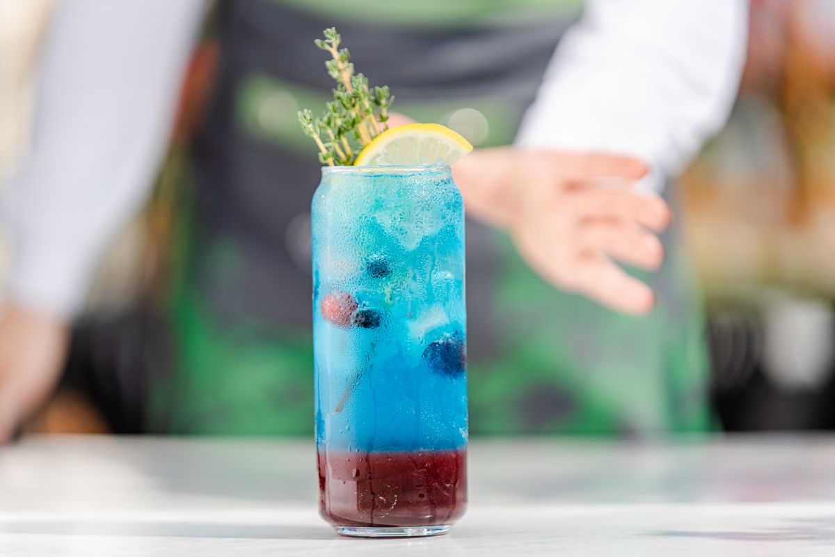 Refreshing blue mocktail with lemon and berries