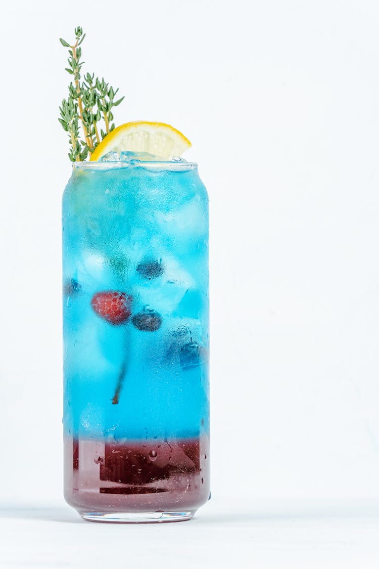 A Refreshing Blue Tropical Drink With Berries And Lemon Slice