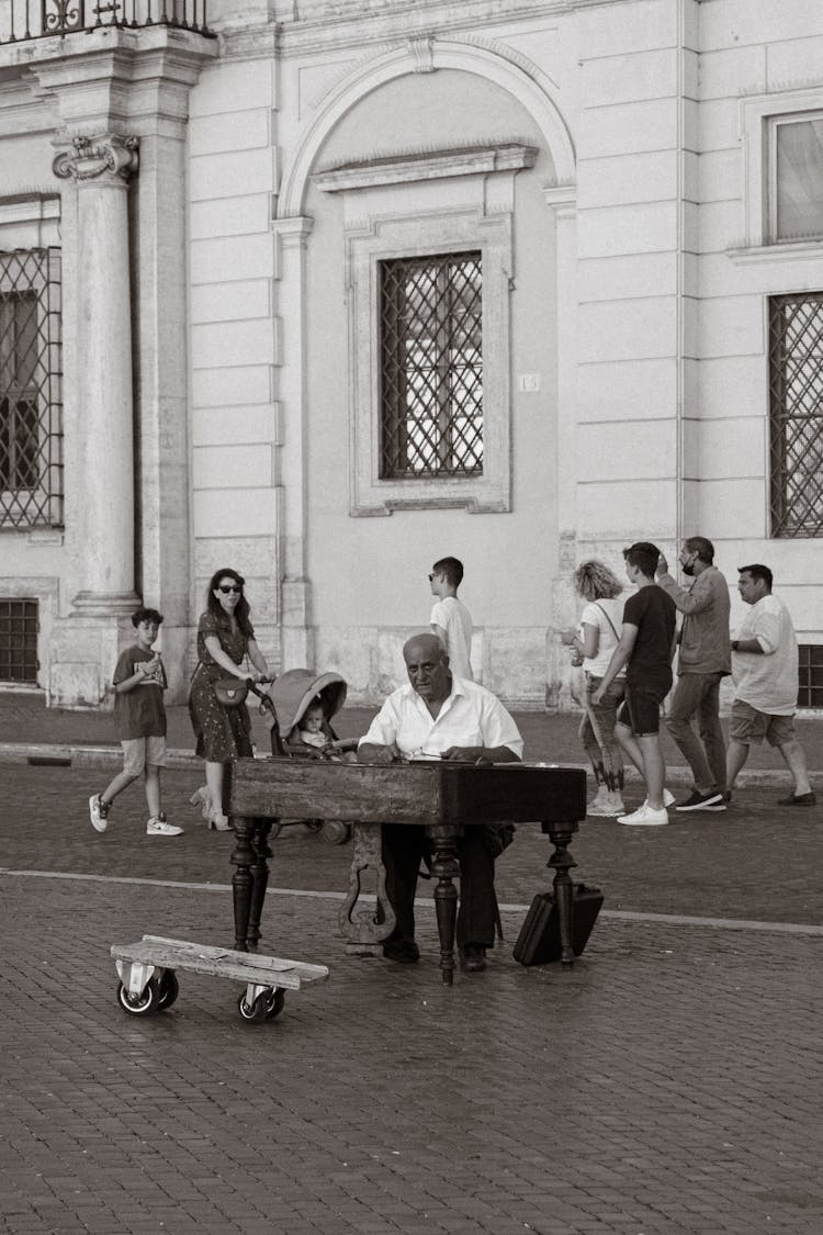 Old Man Playing Music On Instrument On Street