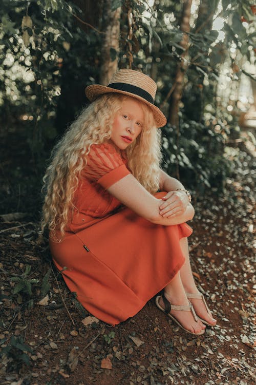 Woman Wearing Dress Sitting in Forest