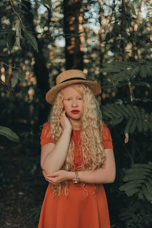 Blonde Model Wearing Hat and Dress In Forest