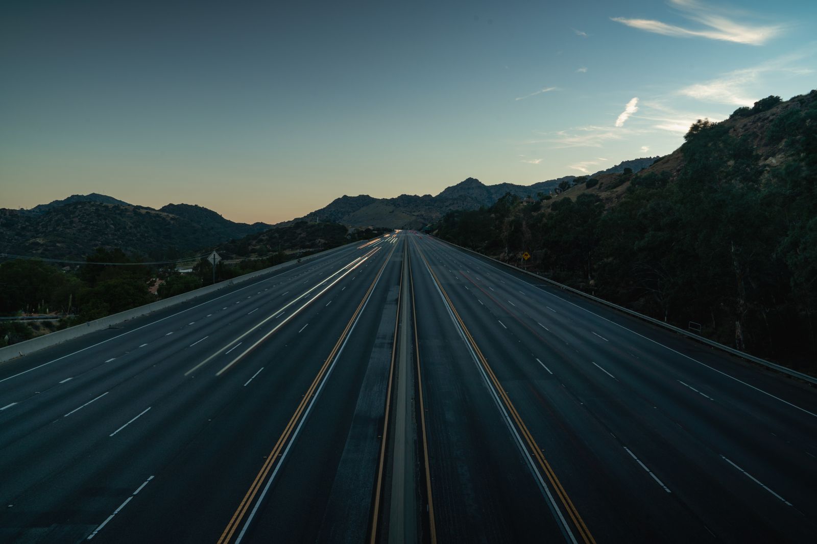 Empty mountain highway at dusk, photo by Anthony Brown on Pexels