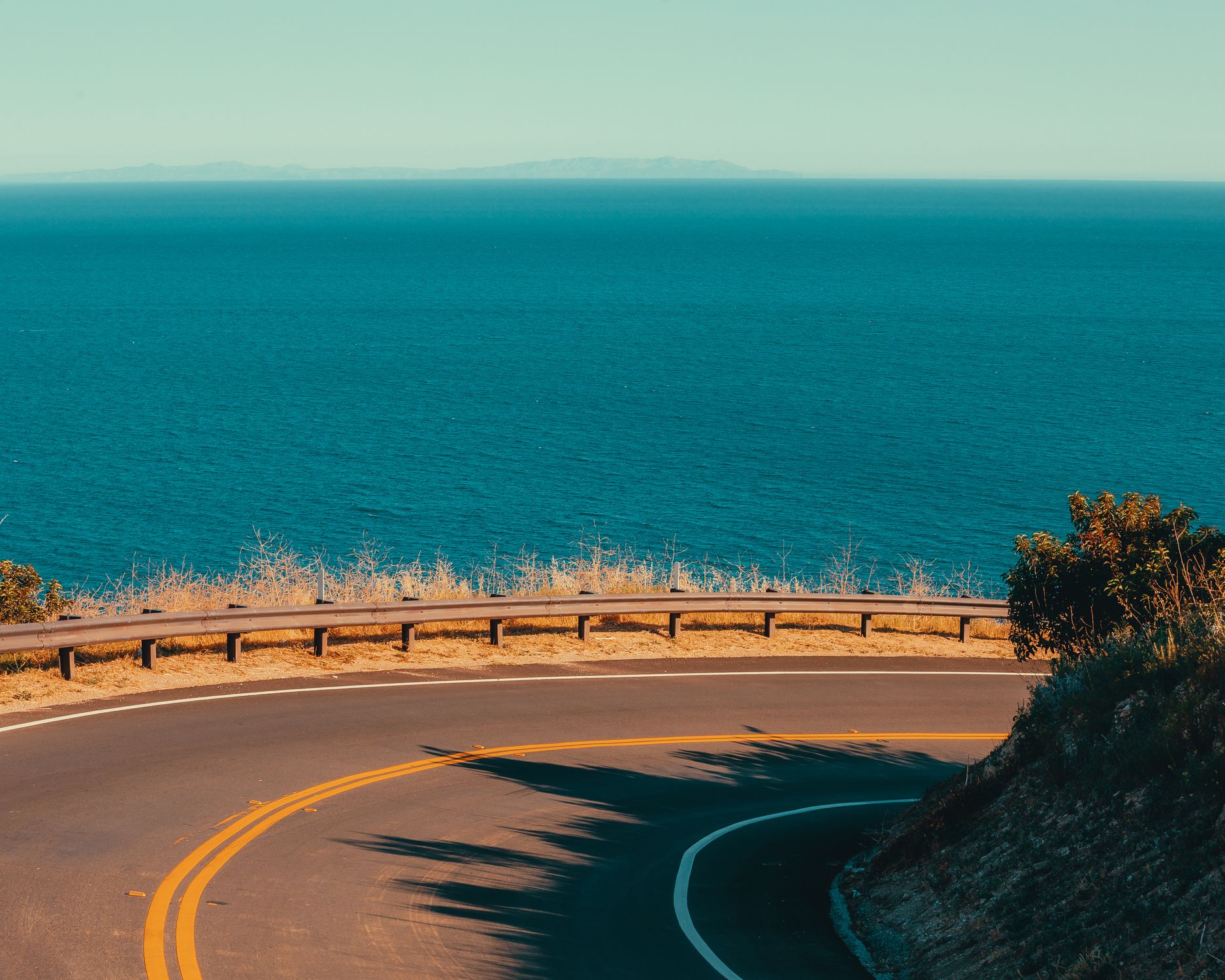Winding road along the Pacific Ocean in Malibu, California. Perfect for road trips.