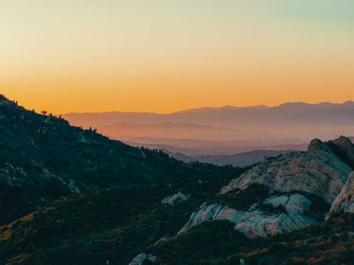 Free A beautiful sunset over the rolling hills of Malibu, California with vibrant colors and stunning scenery. Stock Photo
