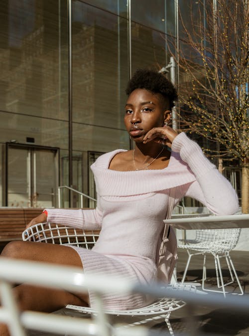 Young Woman Sitting in Chair in Cafe