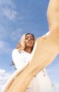 Woman in White Long Sleeve Shirt Under Blue Sky