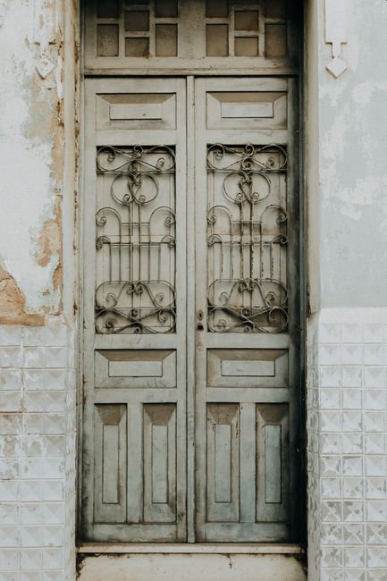 Antique wooden door with ornate ironwork in Aracati, Brazil's charming architecture.