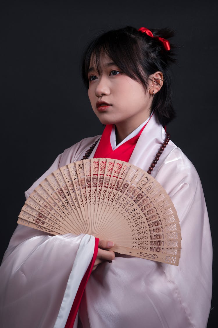 Young Woman In Kimono With Fan