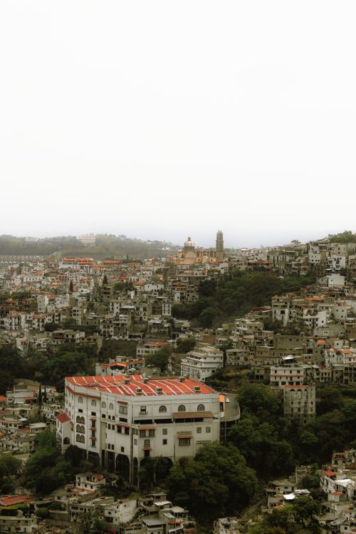 Free An aerial view of a dense urban area with hills and residential buildings. Stock Photo