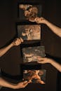 Person Holding Photographs