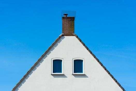 Rooftop showing chimney and surrounding shingles — chimney flashing leak causes and prevention