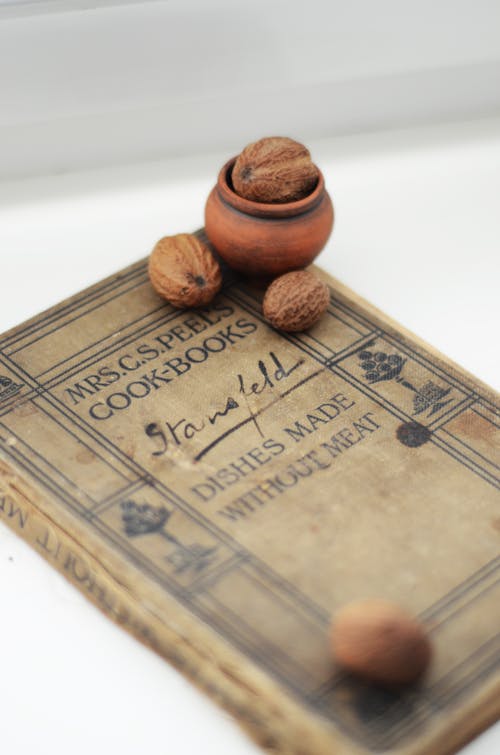 Free Walnuts on Old Vintage Book on Table Stock Photo
