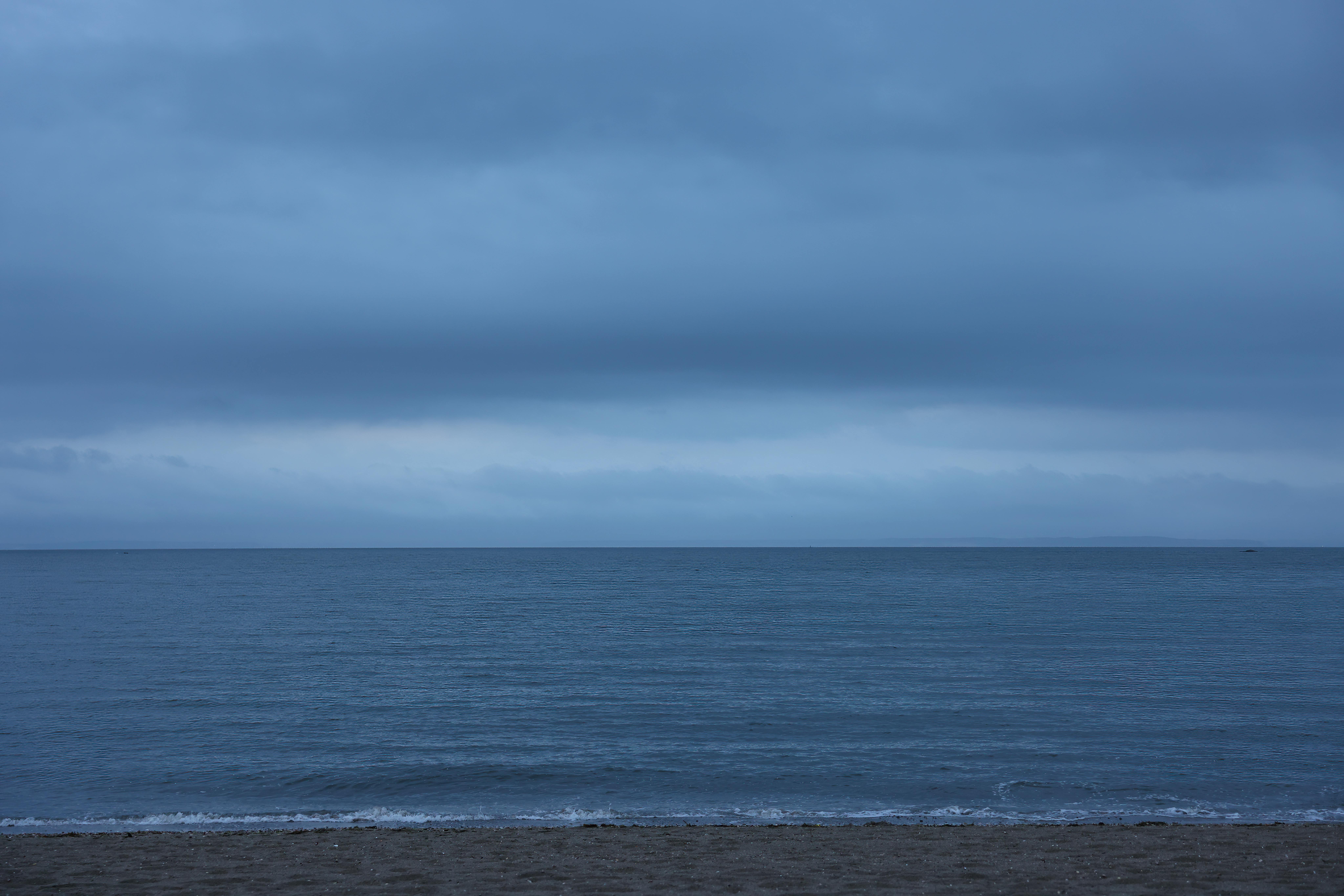 A moody seascape with a gloomy sky over Stamford's beach in Connecticut.