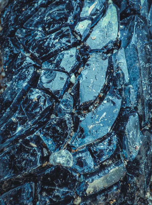 Free Detailed close-up image of broken black glass texture, showcasing unique patterns and reflections. Stock Photo