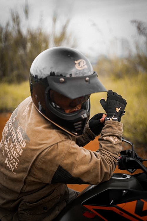 Person in Brown Jacket Wearing Black Helmet