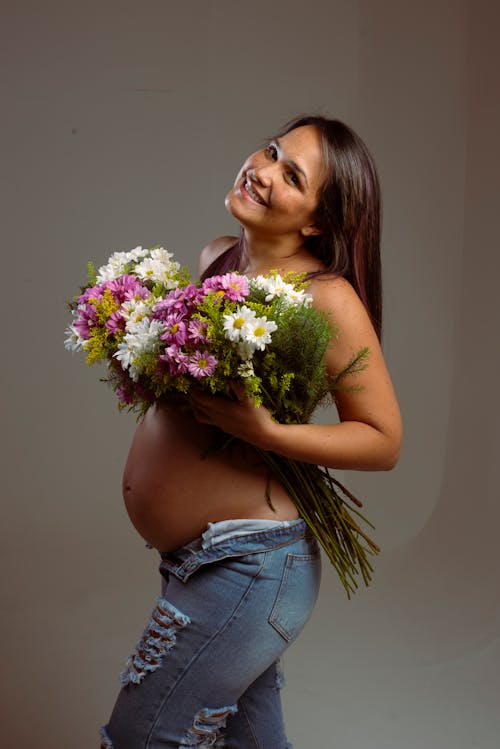 A Pregnant Woman Holding Flowers