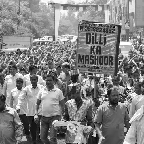 Grayscale Photo of People Gathering on Street