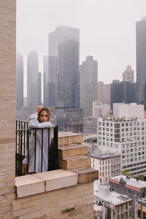 Woman Standing on a Balcony