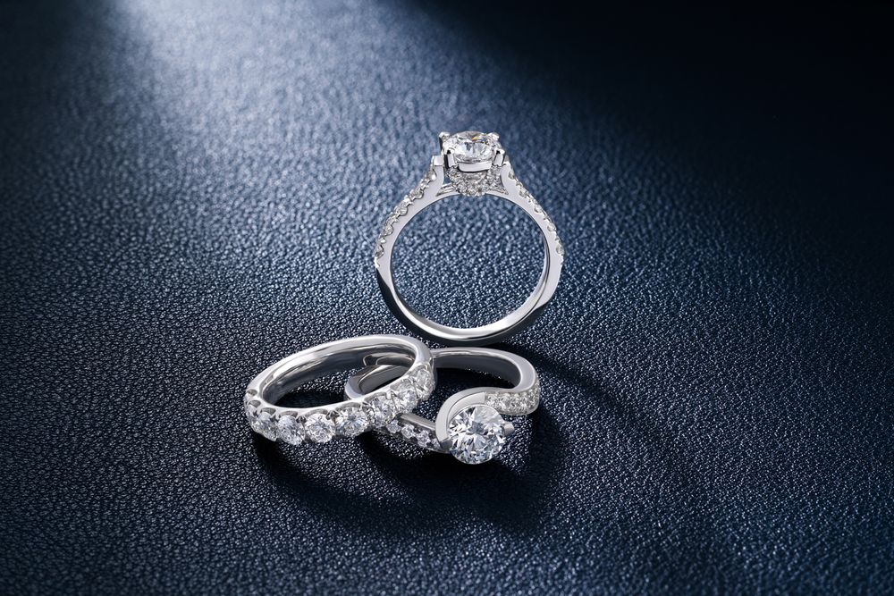 Diamond rings arranged on a dark surface