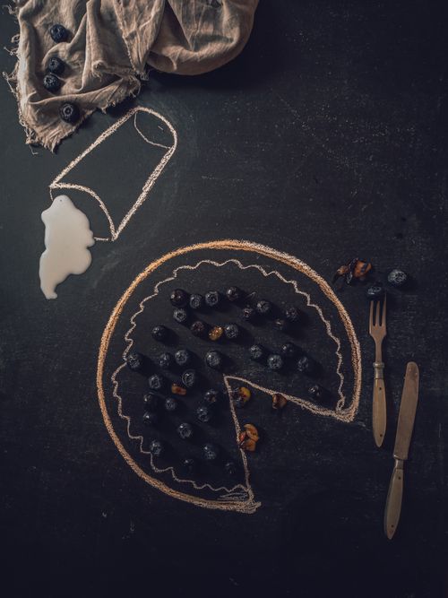 Free Creative chalkboard art showcasing a pizza with blueberries and nuts. Perfect for food and art themes. Stock Photo
