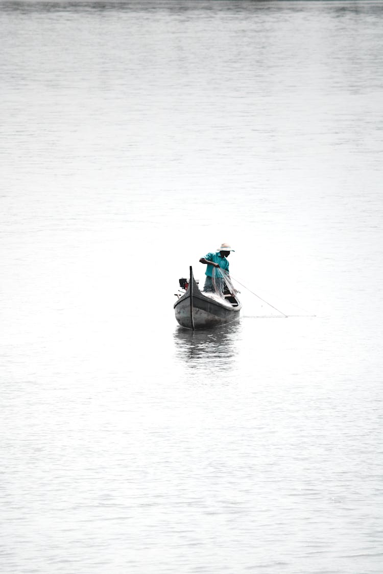 A Man Holding A Fishing Net