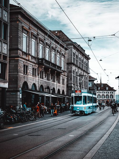 Free Vibrant street view of a tram navigating through Zürich's historic architecture. Stock Photo