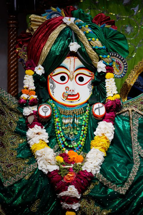 Free A beautifully adorned Hindu deity statue with intricate colorful decorations and floral garlands. Stock Photo