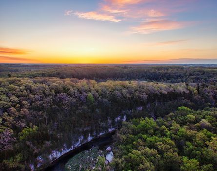 A picturesque aerial view of a Minnesota forest during a vibrant sunset, showcasing nature's beauty.