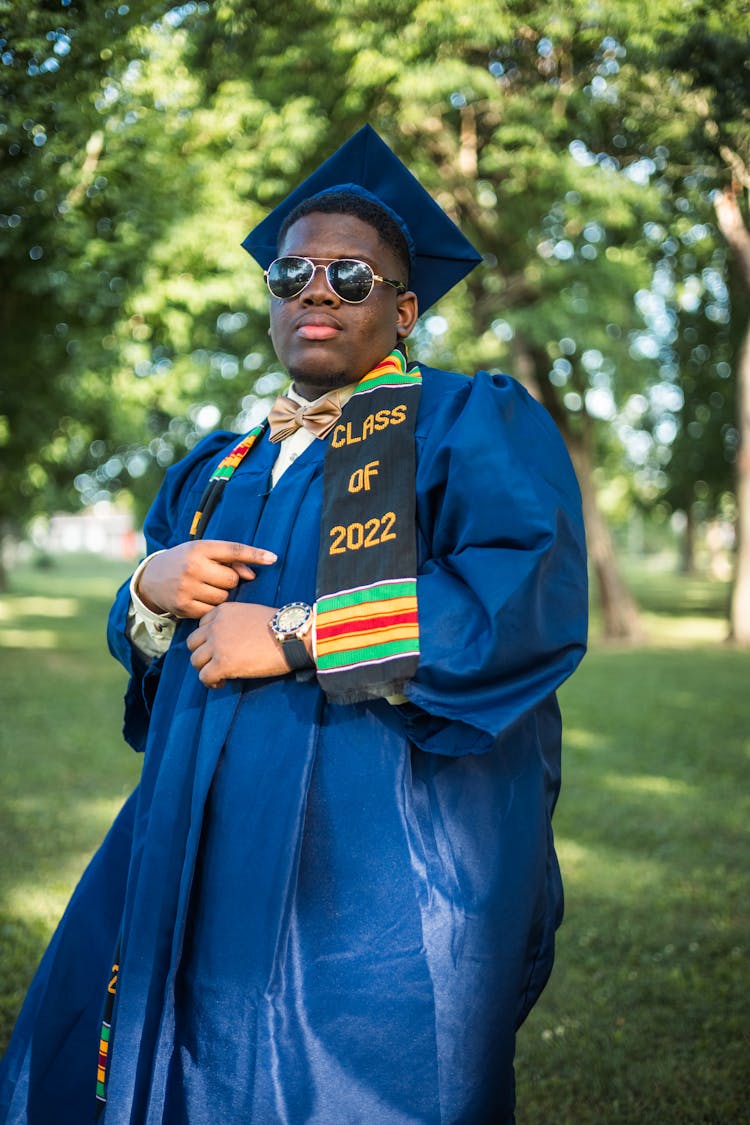 A Man Pointing At His Graduation Stole