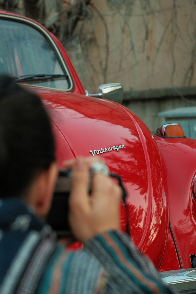 Man Photographing Vintage Car