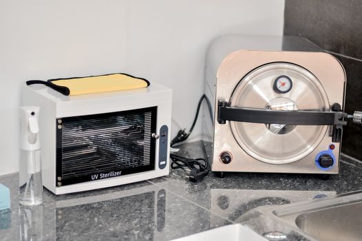 Professional UV sterilizer and autoclave setup in a clean laboratory environment.