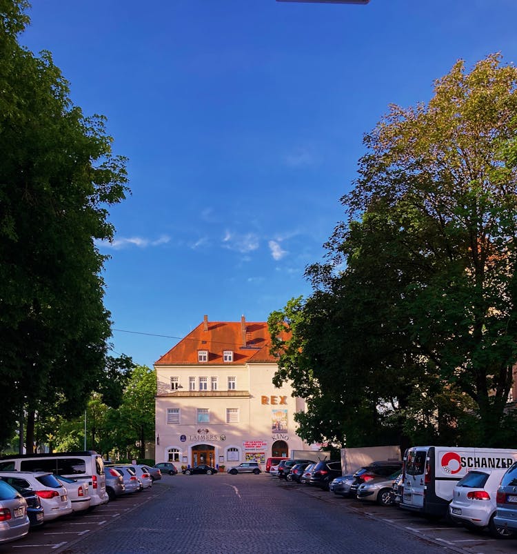 Rows Of Cars Parked Near The Concrete Building