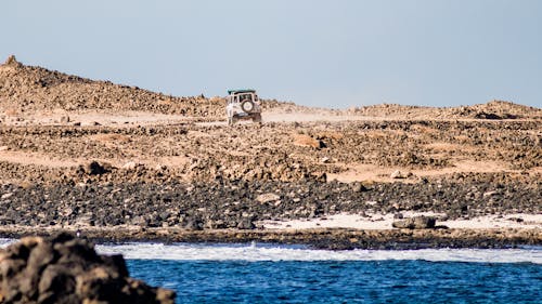 A Jeep Wrangler on Rocky Seashore