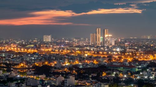 Free Vibrant Ho Chi Minh City skyline illuminated against a dusk sky, featuring modern skyscrapers. Stock Photo