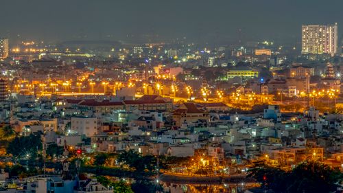 Free Illuminated cityscape of Ho Chi Minh City showcasing vibrant lights and urban skyline. Stock Photo