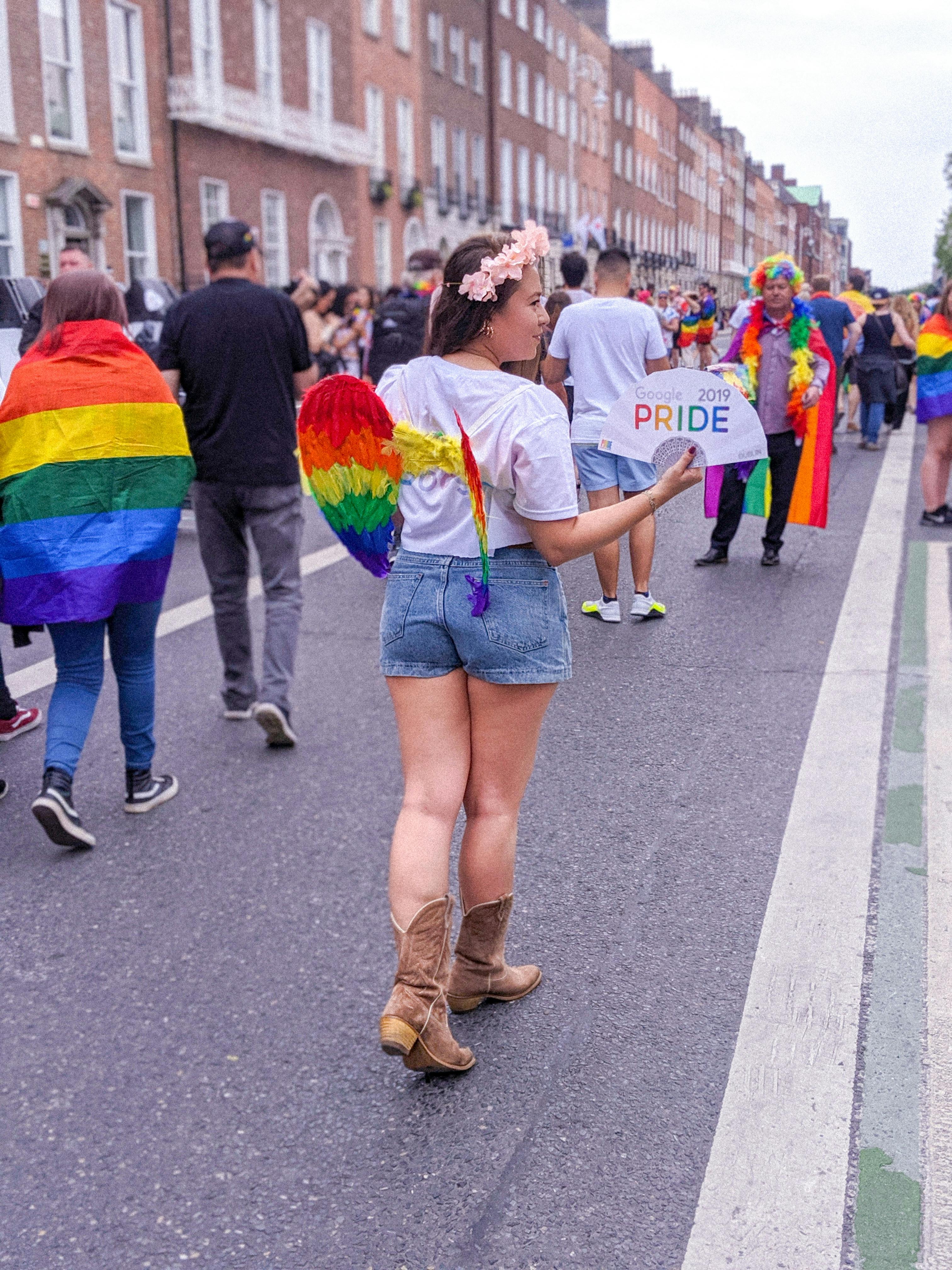 woman in white t shirt and blue denim shorts walking on street