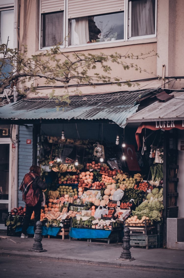 Person Standing In Front Of Fruit Shop